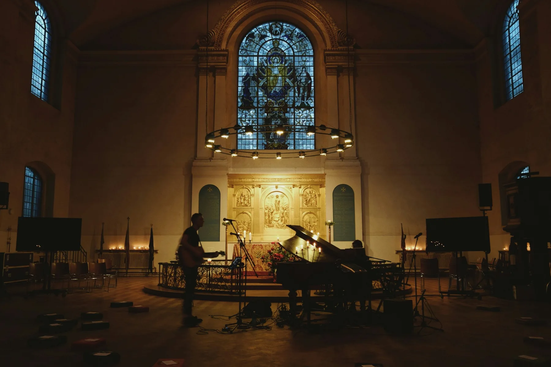 Musicians preparing a worship set inside a church building