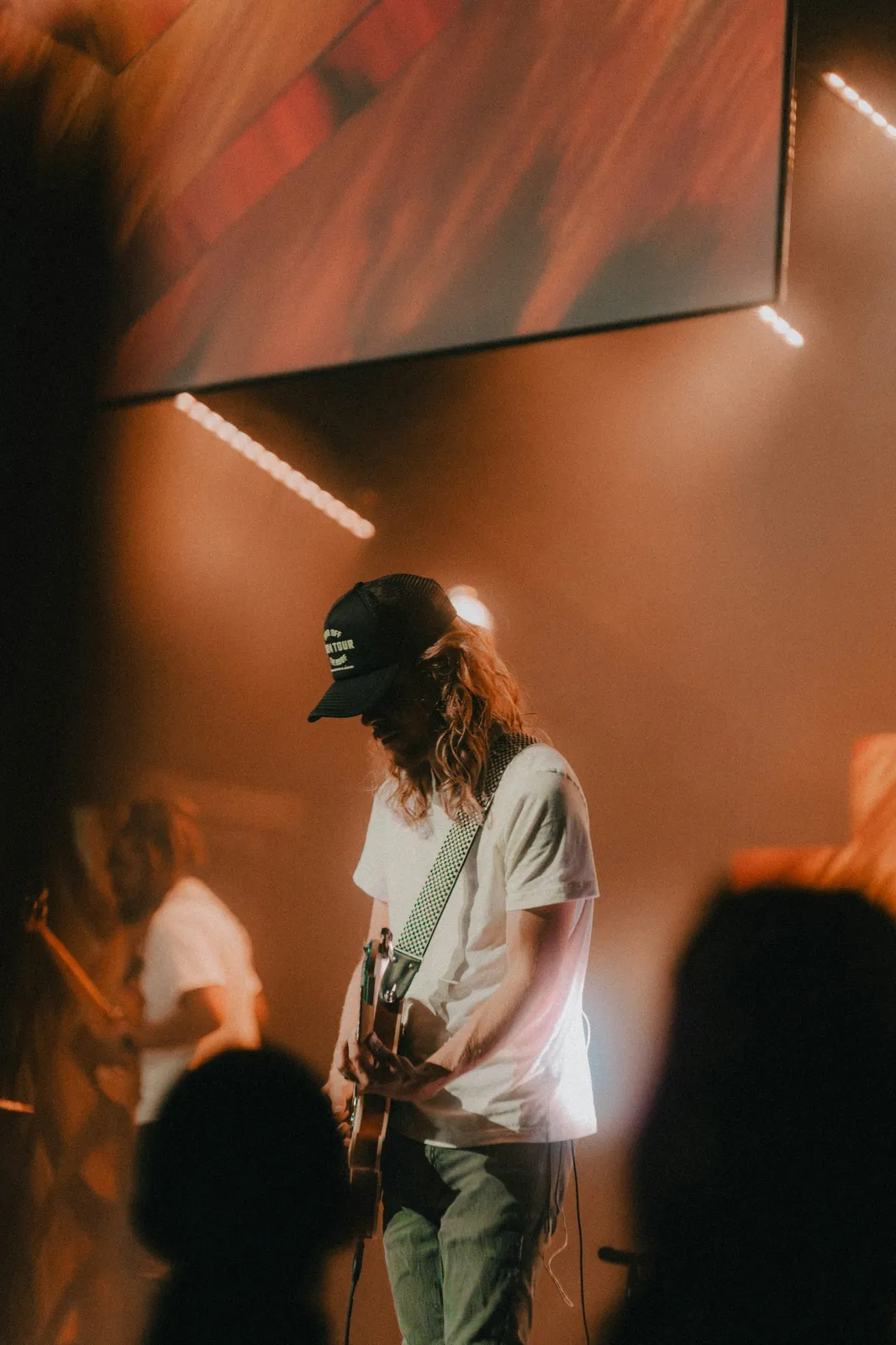 A guitarist serving during a worship gathering