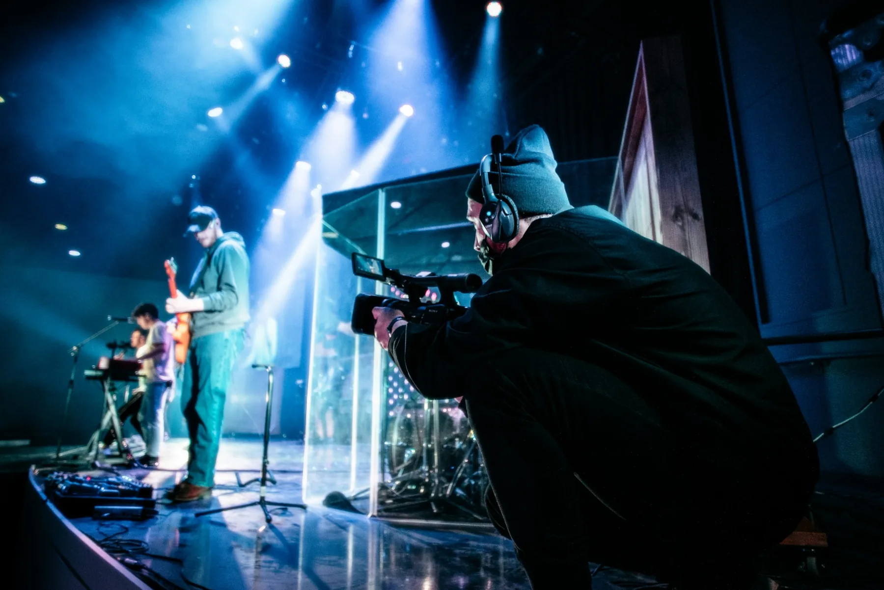 A camera operator filming a live worship gathering