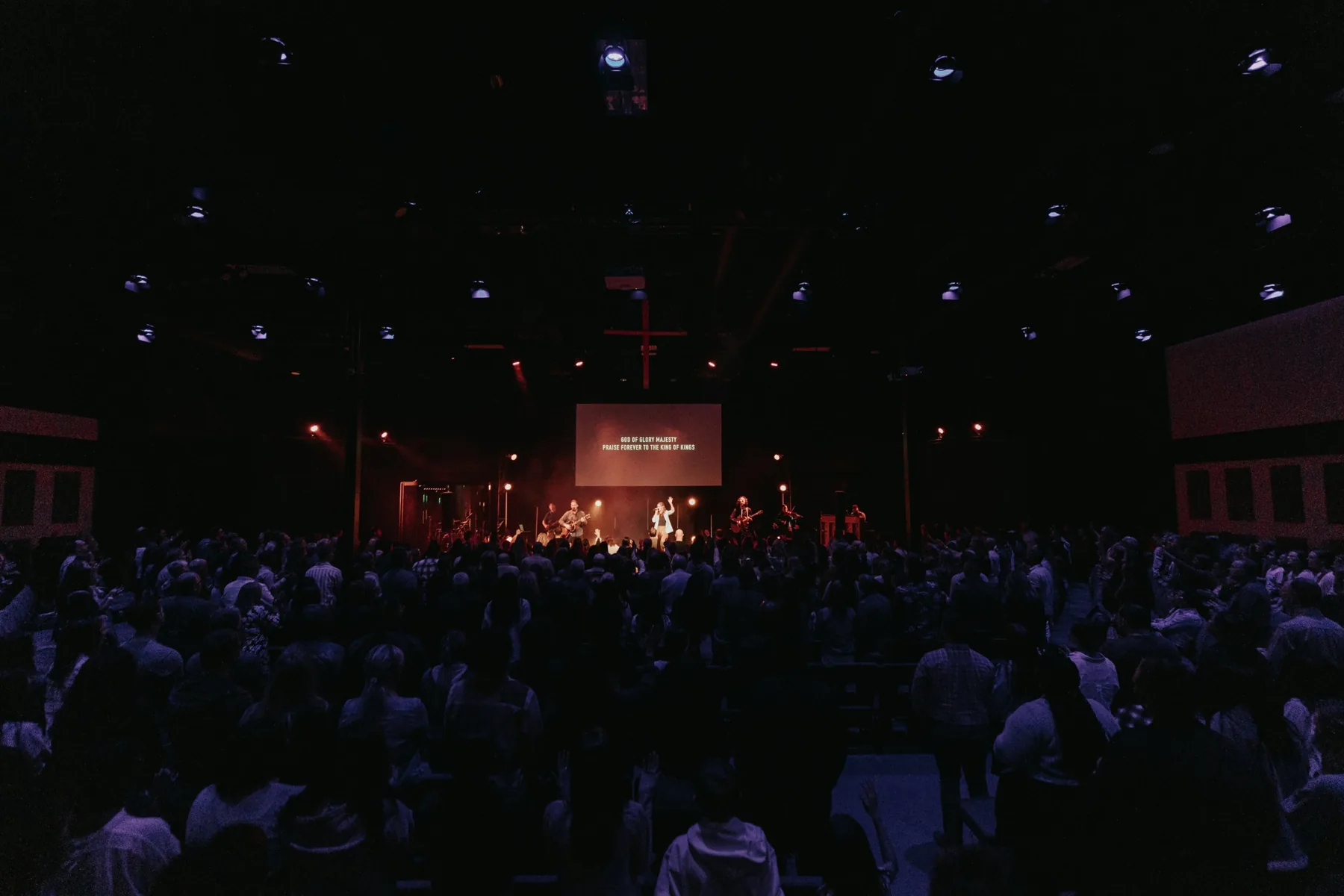 A modern church gathering viewed from the back of the room